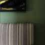 Traveller's London apartment | Guest bedroom detail - seating and painting | Interior Designers